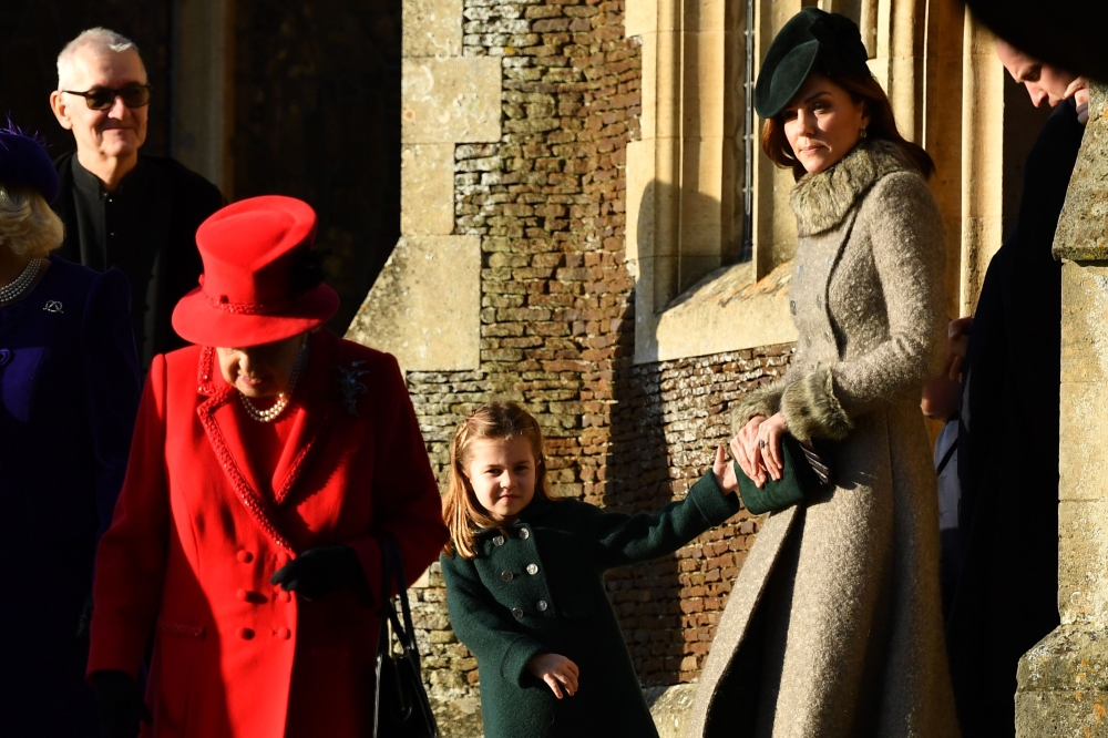(L-R) Britain's Queen Elizabeth II, Britain's Princess Charlotte of Cambridge and Britain's Catherine, Duchess of Cambridge leave after the Royal Family's traditional Christmas Day service at St Mary Magdalene Church in Sandringham, Norfolk, eastern Engla