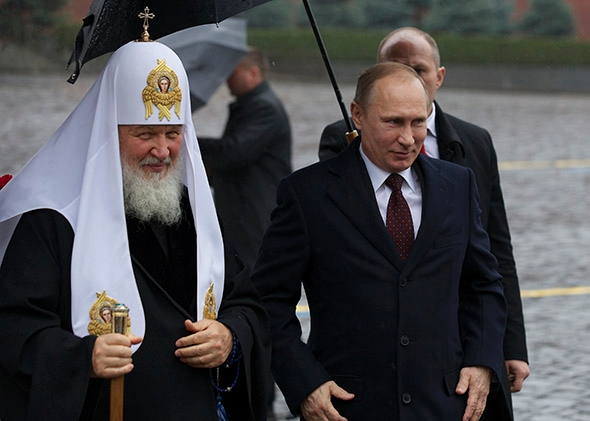 File photo: Russian President Vladimir Putin with Russian Orthodox Patriarch Kirill to place flowers at a statue of Minin and Pozharsky, the leaders of a struggle against foreign invaders in 1612 on Nov 4, 2013. AFP