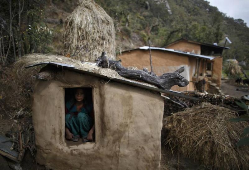 In this 2014 archive photo, a 14-year old girl sits inside a Chaupadi shed in the hills of Legudsen village in Achham District in western Nepal. Reuters / Navesh Chitrakar