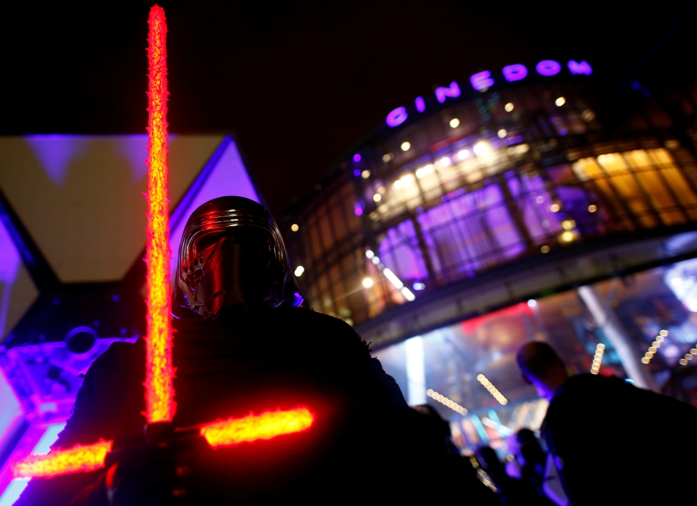 A fan dressed as Kyle Ren awaits at a gala screening of 