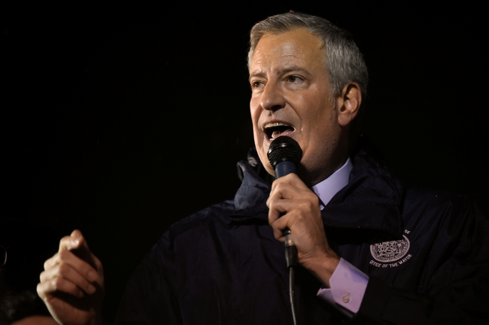 New York City Mayor Bill de Blasio (R) talks during a gathering at Grand Army Plaza in solidarity with the victims after an assailant stabbed five people attending a party at an Hasidic rabbi's home in Monsey, N.Y., on December 28, 2019, while they were c