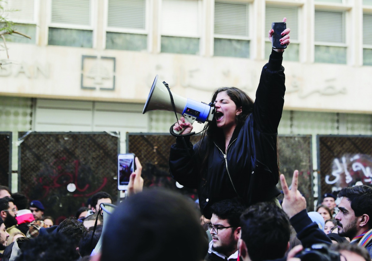 A Lebanese anti-government demonstrator yells slogans as she takes part in a rally in front of the central bank building in the capital Beirut on December 30, 2019.  AFP / Anwar Amro