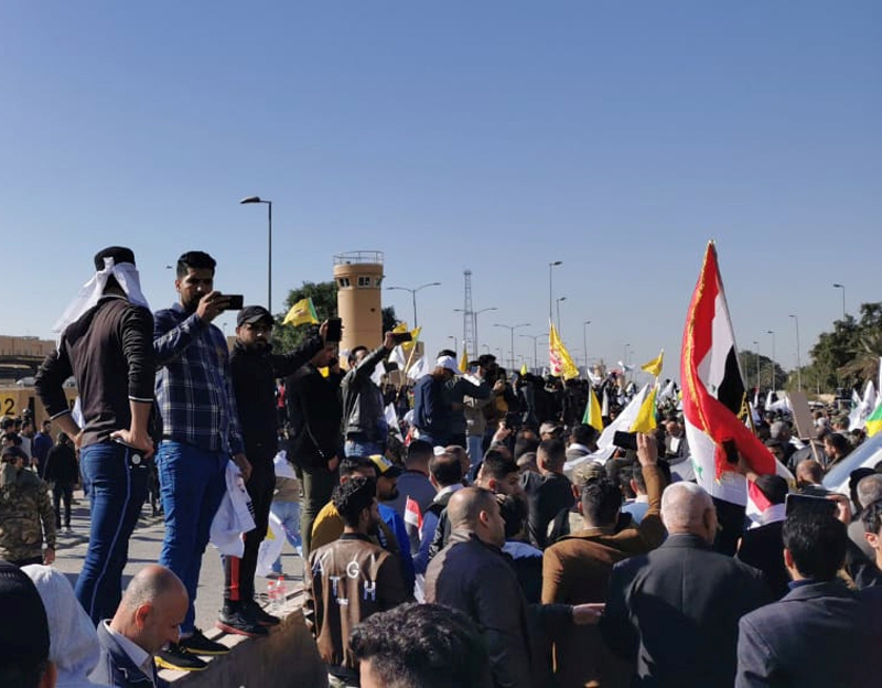 Protesters gather to condemn air strikes on bases belonging to Hashd al-Shaabi (paramilitary forces), outside the main gate of the US Embassy in Baghdad, Iraq on December 31, 2019. (REUTERS/Thaier al-Sudani)