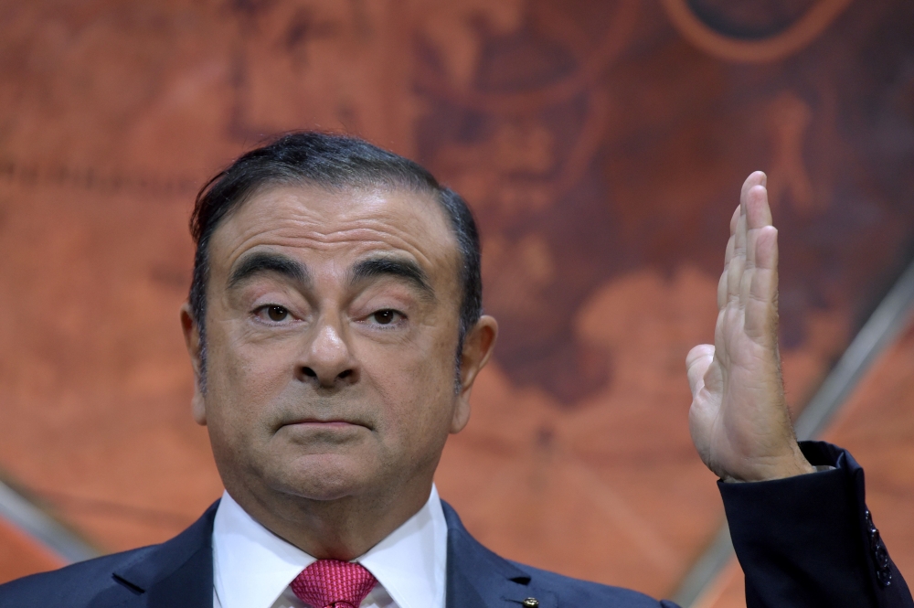 Carlos Ghosn gestures as he addresses a press conference in Paris on September 15, 2017 to present the Renault Nissan group strategy. AFP / Eric Piermont
