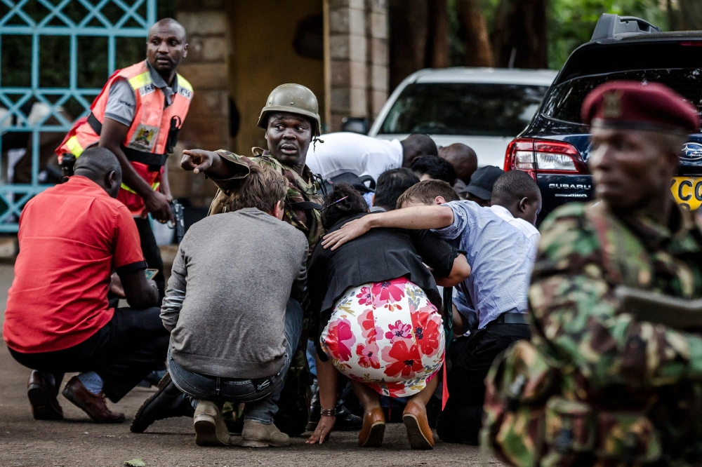  In this file photo taken on January 15, 2019 Special forces protect people at the scene of an explosion at a hotel complex in Nairobi's Westlands suburb.  AFP / Luis Tato