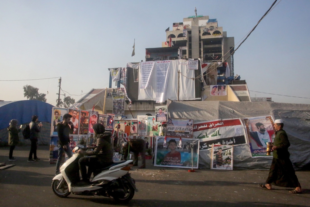 Iraqis walk at Baghdad's Tahrir Square on January 3, 2020. (AFP)