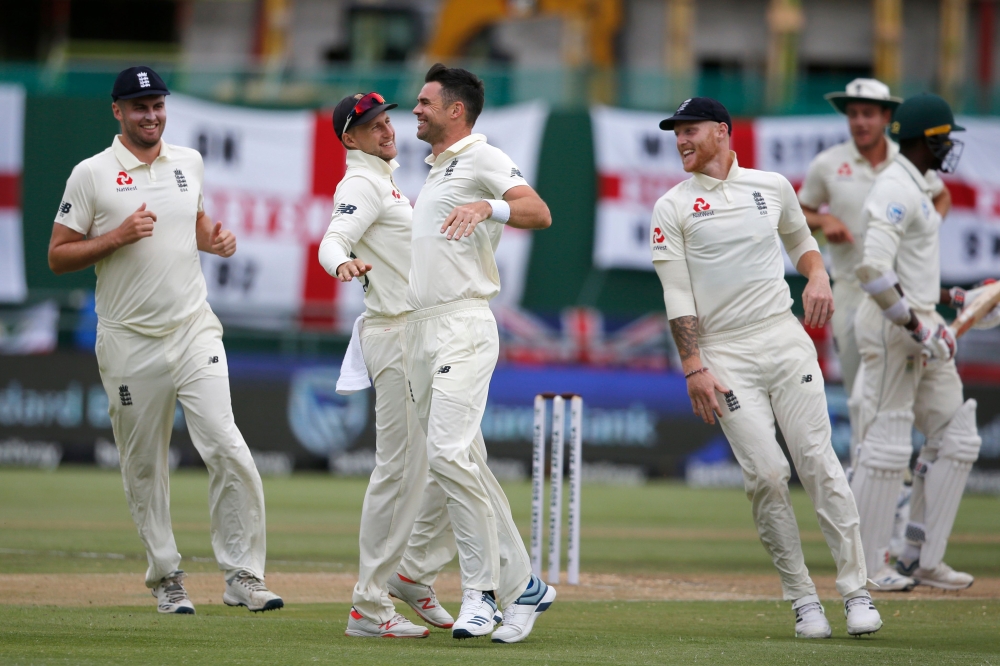 England's James Anderson (3rdL) celebrates with teammates after the dismissal of South Africa's Kagiso Rabada (R) during the third day of the second Test cricket match between South Africa and England at the Newlands stadium in Cape Town on January 5, 202