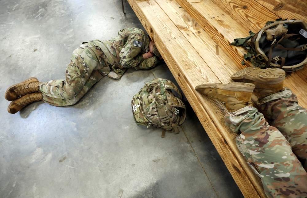 U.S. Army paratroopers from the 2nd Battalion, 504th Parachute Infantry Regiment, 1st Brigade Combat Team, 82nd Airborne Division, rest before their departure for the Middle East from Fort Bragg, North Carolina, U.S. January 4, 2020. REUTERS/Jonathan Drak