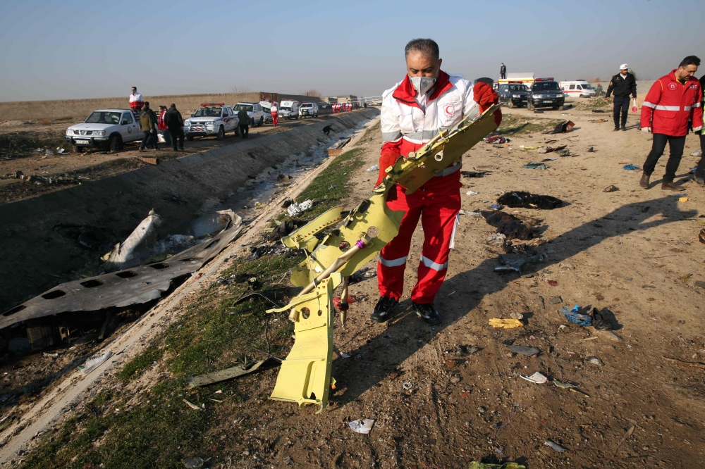 Rescueeams recover debris from a field after a Ukrainian plane carrying 176 passengers crashed near Imam Khomeini airport in the Iranian capital Tehran early in the morning on January 8, 2020, killing everyone on board.  AFP 