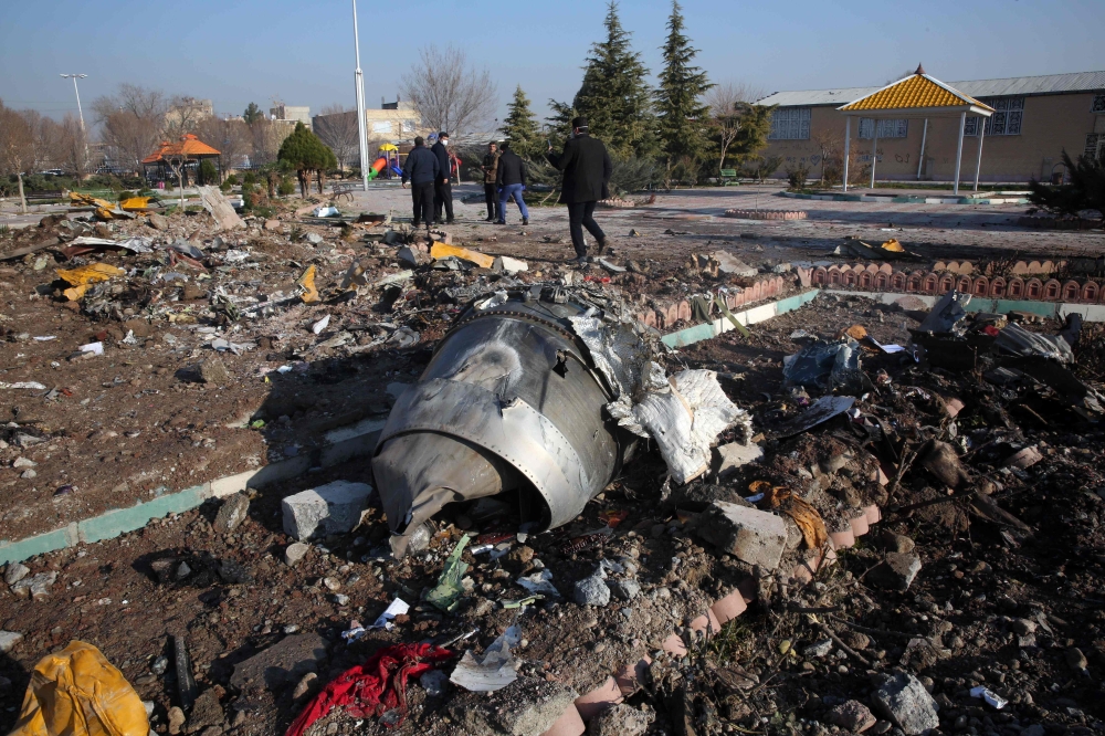 Rescue teams work amidst debris after a Ukrainian plane carrying 176 passengers crashed near Imam Khomeini airport in the Iranian capital Tehran early in the morning on January 8, 2020, killing everyone on board.  AFP 