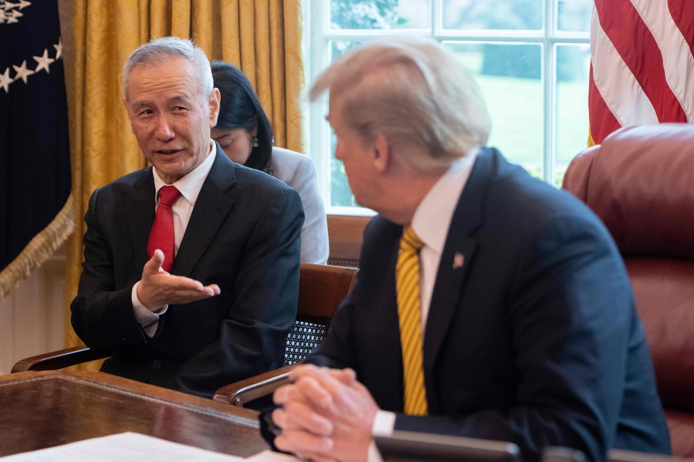 (FILES) In this file photo China's Vice Premier Liu He (L) speaks with US President Donald Trump during a trade meeting in the Oval Office at the White House in Washington, DC, on April 4, 2019. AFP / Jim Watson 