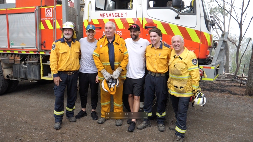 Australia cricketers Tim Paine and Nathan Lyon pose with firefighters as they visit areas affected by bushfires in Southern Highlands, New South Wales, Australia, January 8, 2020 in this still image obtained from social media video. CRICKET AUSTRALIA/via 