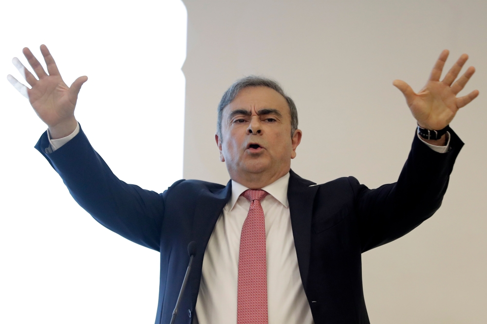 Former Renault-Nissan boss Carlos Ghosn gestures as he addresses a large crowd of journalists on his reasons for dodging trial in Japan, where he is accused of financial misconduct, at the Lebanese Press Syndicate in Beirut on January 8, 2020. AFP / JOSEP
