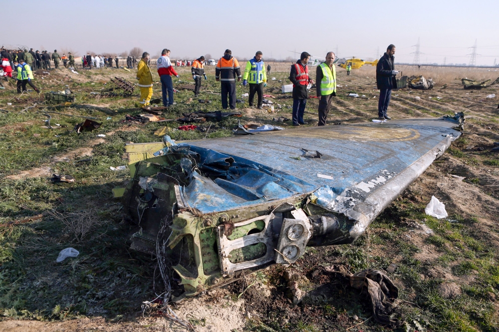 FILE PHOTO: Rescue teams are seen at the scene of a Ukrainian airliner that crashed shortly after take-off near Imam Khomeini airport in the Iranian capital Tehran. AFP/ Akbar TAVAKOLI