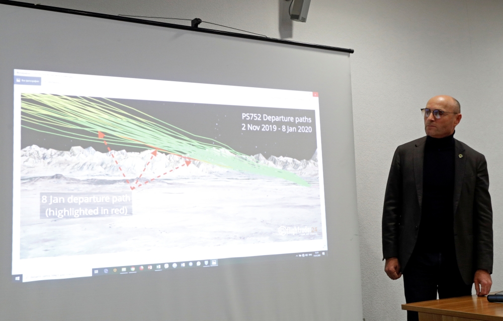 Ukraine International Airlines President Yevhenii Dykhne stands next to a map of flight PS-752's departure paths at a news briefing about the crash of the Boeing 737-800 plane, flight PS-752, on the outskirts of Tehran, at the Boryspil International Airpo