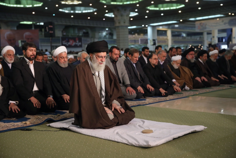 Iran Supreme Leader Ayatollah Ali Khamenei leading Friday prayers at the Grand Mosallah mosque in  Tehran while flanked by President Hassan Rouhani (C-L, behind) January 17, 2020. Office of Iran's Supreme Leader Ayatollah Ali Khamenei / AFP