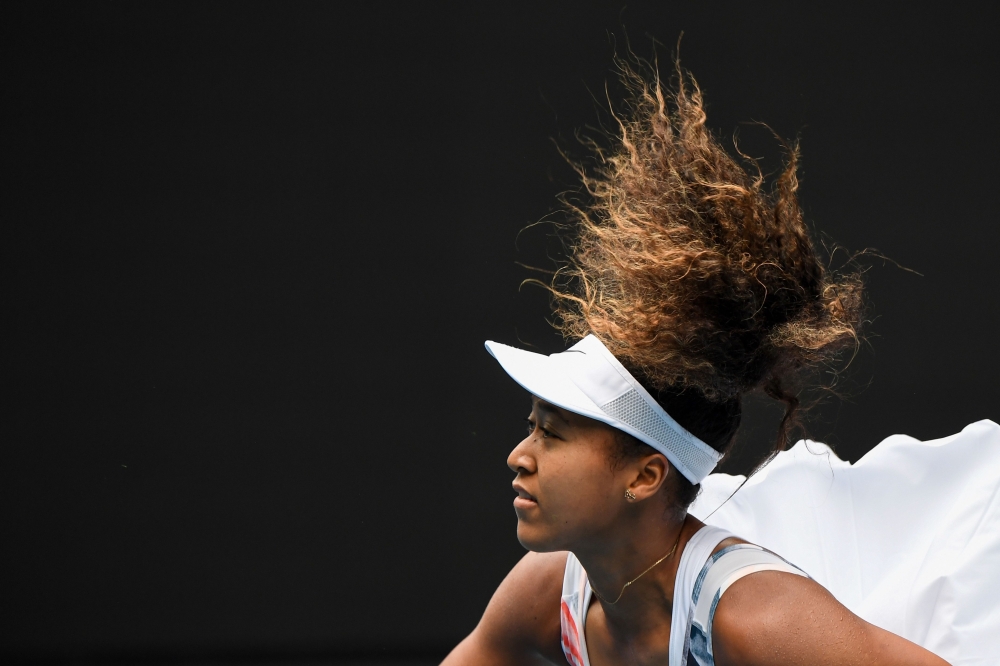 Japan's Naomi Osaka serves against Czech Republic's Marie Bouzkova during their women's singles match on day one of the Australian Open tennis tournament in Melbourne on January 20, 2020. AFP / William West 