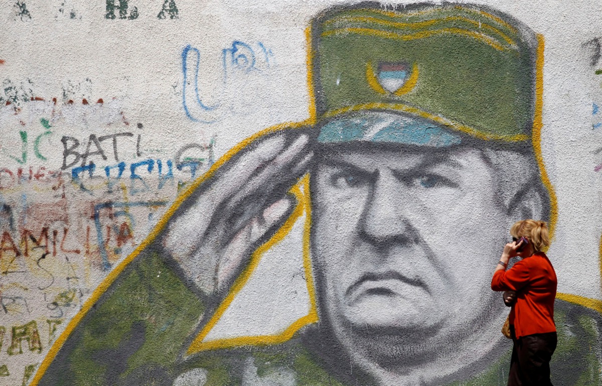 A woman walks past graffiti of Bosnian Serb wartime general Ratko Mladic in a suburb of Belgrade, Serbia, May 27, 2011. Reuters / Stoyan Nenov