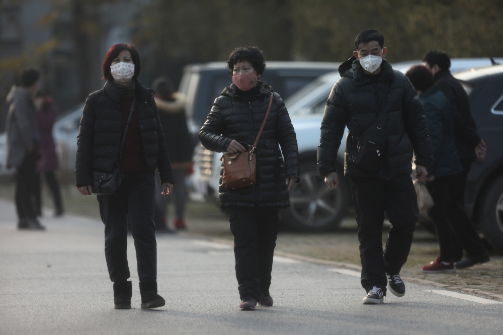 People wearing masks are seen at the Jinyintan hospital, where the patients with pneumonia caused by the new strain of coronavirus are being treated, in Wuhan, Hubei province, China January 20, 2020. REUTERS/Stringer CHINA OUT.