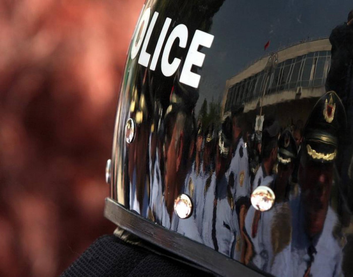 Albanian policemen are reflected in the helmet of a riot policeman in Tirana, Albania, May 19, 2011. Reuters/Arben Celi