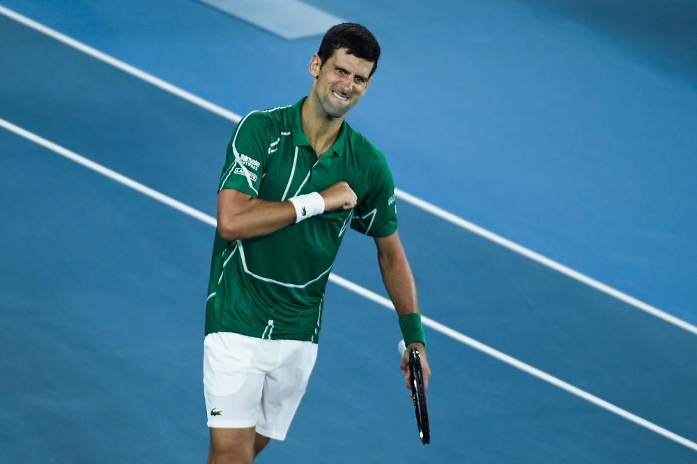 Serbia's Novak Djokovic celebrates his victory against Switzerland's Roger Federer during their men's singles semi-final match on day eleven of the Australian Open tennis tournament in Melbourne on January 30, 2020. (AFP / Saeed Khan)