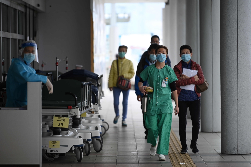 Medical staff are seen outside Princess Margaret Hospital in Hong Kong on February 4, 2020. AFP / Anthony Wallace 