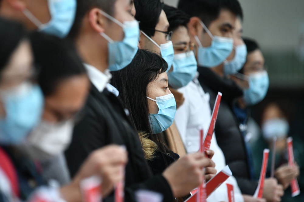 Local medical workers hold a strike near Queen Mary Hospital as they demand the city close its border with China to reduce the coronavirus spreading, in Hong Kong on February 3, 2020.