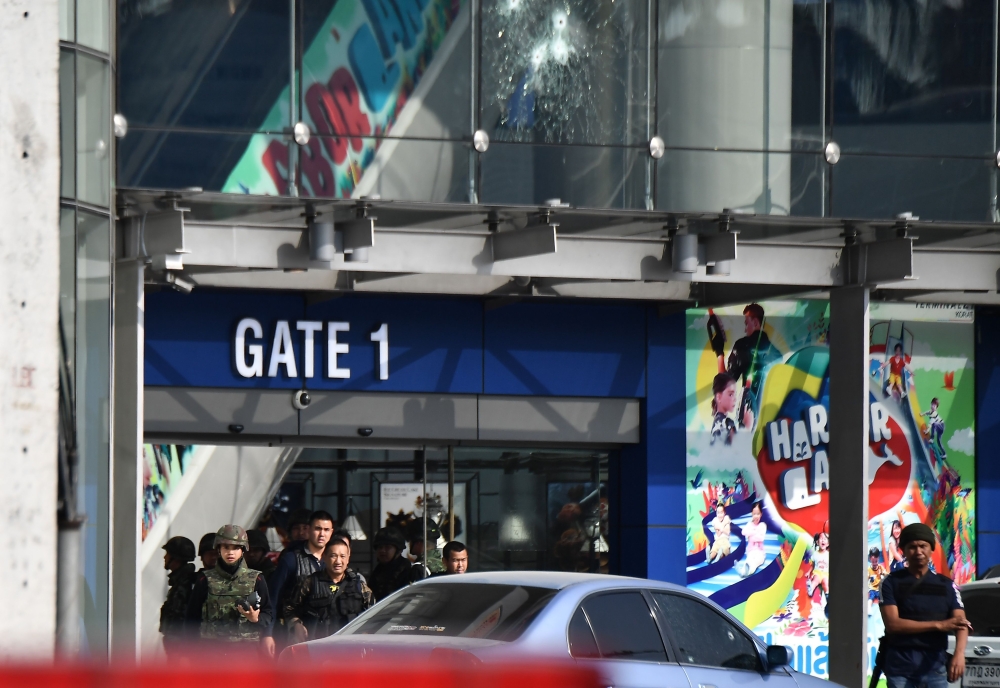 Bullet holes (top C) are seen on the exterior of the Terminal 21 mall, where a mass shooting took place, in the Thai northeastern city of Nakhon Ratchasima on February 9, 2020. A Thai soldier who killed at least 20 people and holed up in a mall overnight 