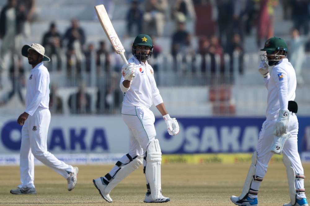 Pakistan's Haris Sohail (C) celebrates after scoring a half century (50 runs) as Bangladesh's wicketkeeper Liton Das (R) looks on during the third day of the first cricket Test match between Pakistan and Bangladesh at the Rawalpindi Cricket Stadium in Raw