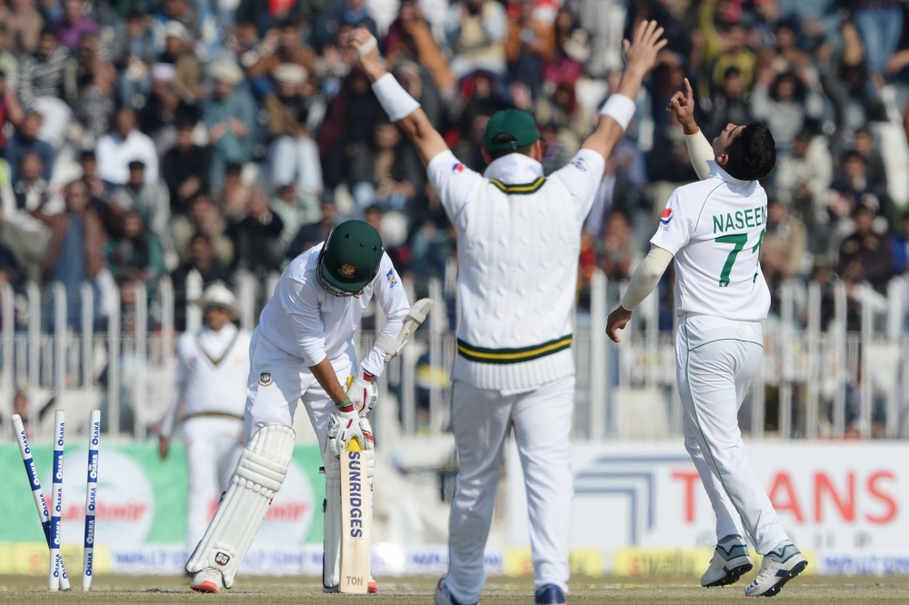 Pakistan's bowler Naseem Shah (R) celebrates after taking the wicket of Bangladesh's Saif Hassan (L) during the third day of the first cricket Test match between Pakistan and Bangladesh at the Rawalpindi Cricket Stadium in Rawalpindi on February 9, 2020. 
