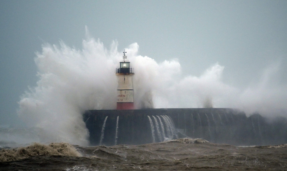Waves crash over Newhaven Lighthouse on the south coast of England on February 9, 2020, as Storm Ciara swept over the country / AFP / GLYN KIRK