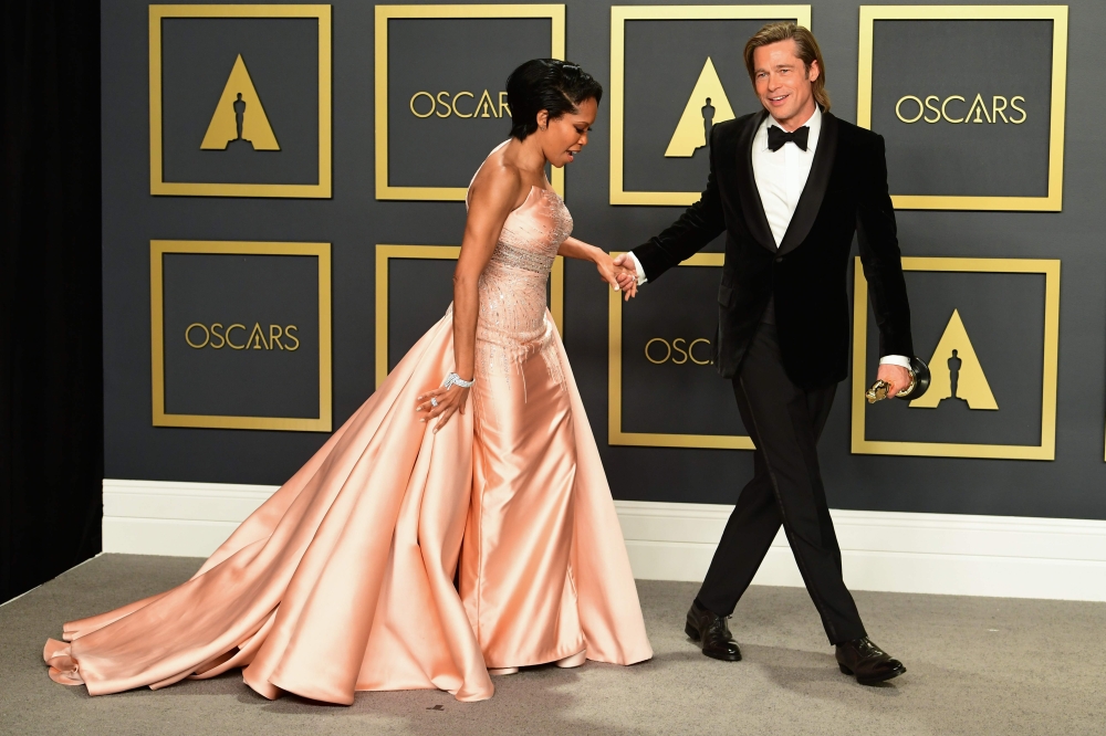 US actor Brad Pitt poses in the press room with the Oscar for Best Supporting Actor along with actress US actress Regina King during the 92nd Oscars at the Dolby Theater in Hollywood, California on February 9, 2020. AFP / FREDERIC J. BROWN