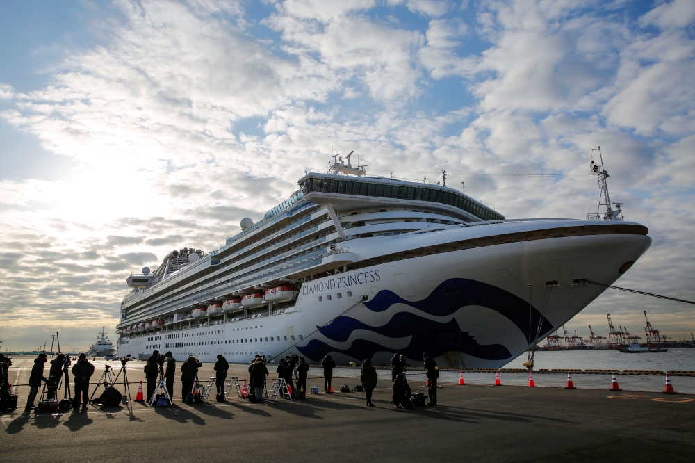 Cruise ship Diamond Princess anchored at Daikoku Pier Cruise Terminal in Yokohama Journalists are seen next to the Cruise ship Diamond Princess, where 10 more people were tested positive for coronavirus on Thursday, as it is anchored at Daikoku Pier Cruis