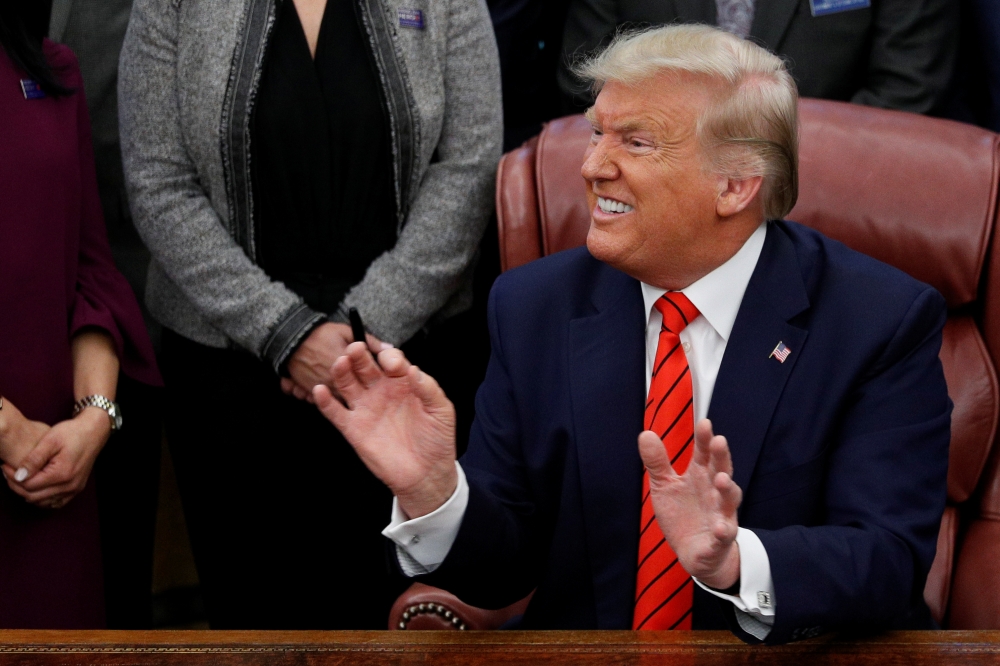 U.S. President Donald Trump reacts to a question from a reporter following a signing ceremony for the Supporting Veterans in STEM Careers Act inside the Oval Office of the White House in Washington, U.S., February 11, 2020. REUTERS/Tom Brenner