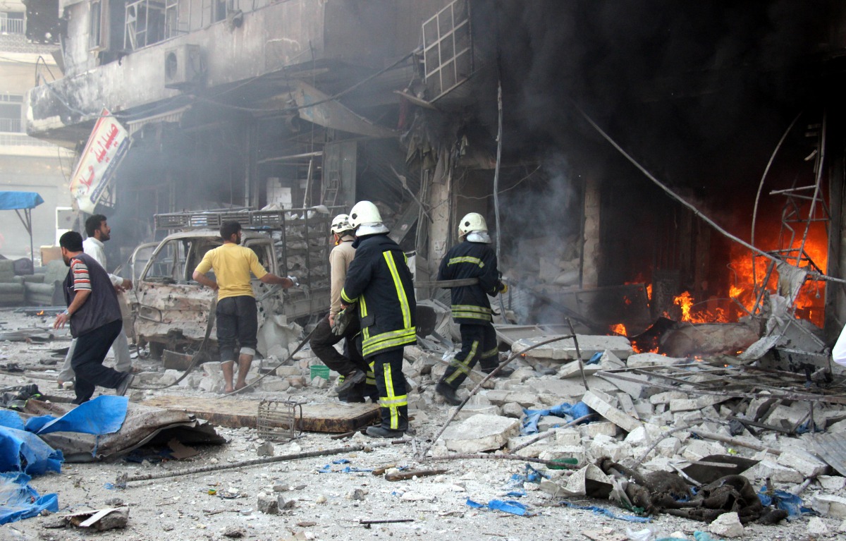 Fire fighters extinguish a fire which broken out after Russian forces staged air-strike over residential areas in Tariq al-Bab neighborhood of Aleppo, Syria, on April 23, 2016. Anadolu Agency / ?brahim Ebu Leys