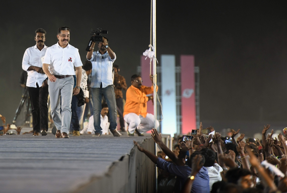 Makkal Needhi Mayyam party founder Kamal Haasan is cheered by supporters at an election rally in Coimbatore, Tamil Nadu, India. AFP file photo / Arun Sankar 