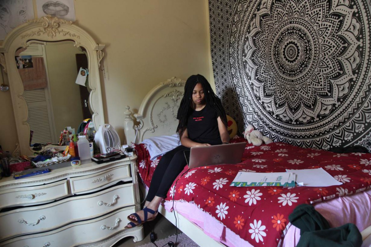 Kenyan climate activist Makenna Muigui works on her computer at her home in Nairobi, Kenya, February 13, 2020. Thomson Reuters Foundation/Nita Bhalla 