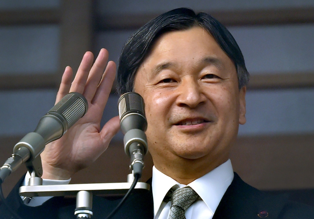 Japan's Emperor Naruhito waving to well-wishers during a New Year's greeting ceremony at the Imperial Palace in Tokyo. AFP / Kazuhiro NOGI