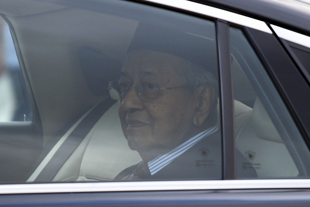 Malaysia’s former prime minister Mahathir Mohamad looks on as he leaves the National Palace in Kuala Lumpur on February 24, 2020.  AFP / Mohd RASFAN