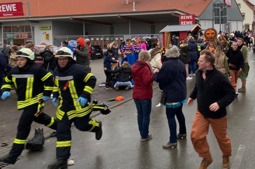 People react at the scene after a car ploughed into a carnival parade injuring several people in Volkmarsen, Germany February 24, 2020. Elmar Schulten/Waldeckische Landeszeitung via Reuters. 