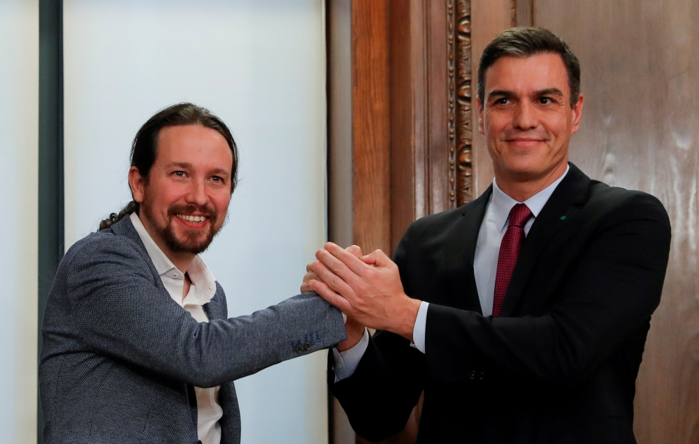 Pedro Sanchez is congratulated by Spanish far-left Unidas Podemos coalition leader Pablo Iglesias after winning vote to elect a premier at the Spanish Congress in Madrid on January 7, 2020. AFP / Pierre-Philippe Marcou