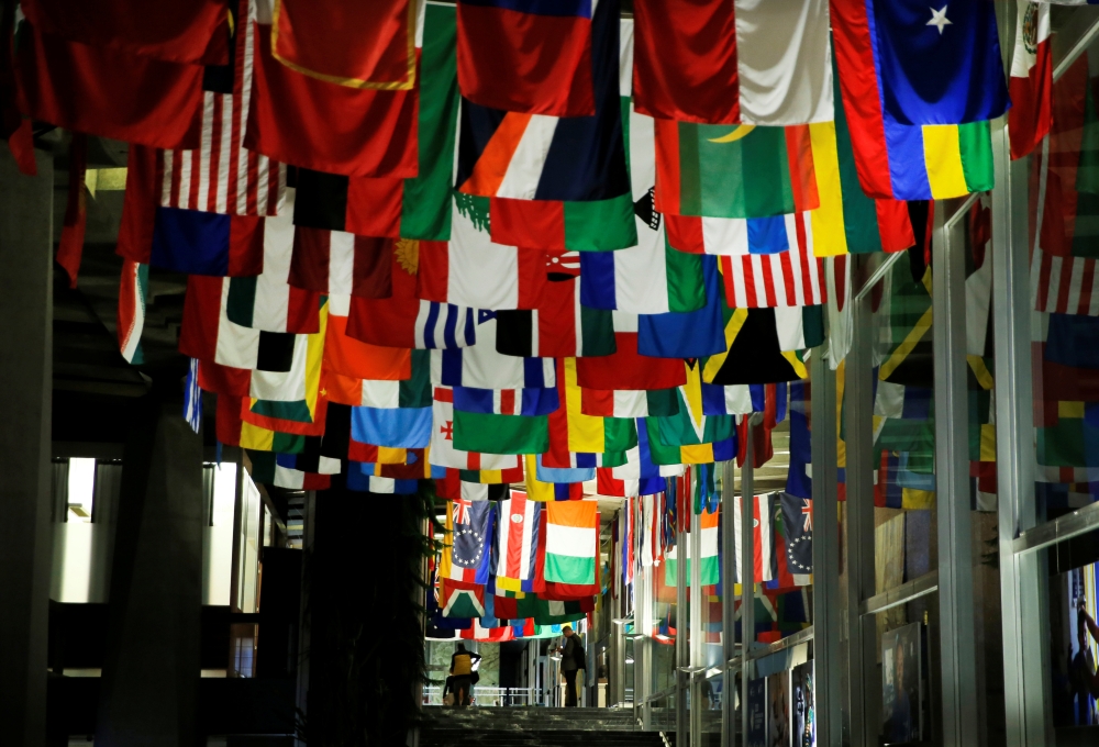A staff reads his mobile device after a news conference of the WHO-China joint mission on COVID-19 coronavirus at the World Health Organization (WHO) in Geneva, Switzerland, 25 February, 2020. Reuters/Denis Balibouse
 