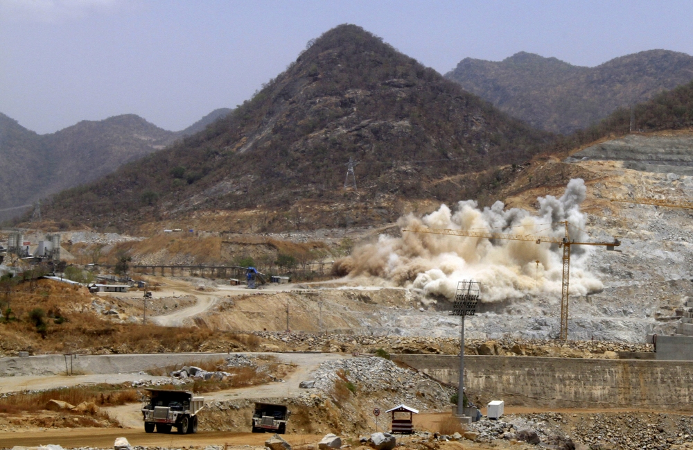 File photo: A cloud of dust rises from a dynamite blast as part of construction work at Grand Renaissance Dam, Ethiopia, March 31, 2015. Reuters / Tiksa Negeri