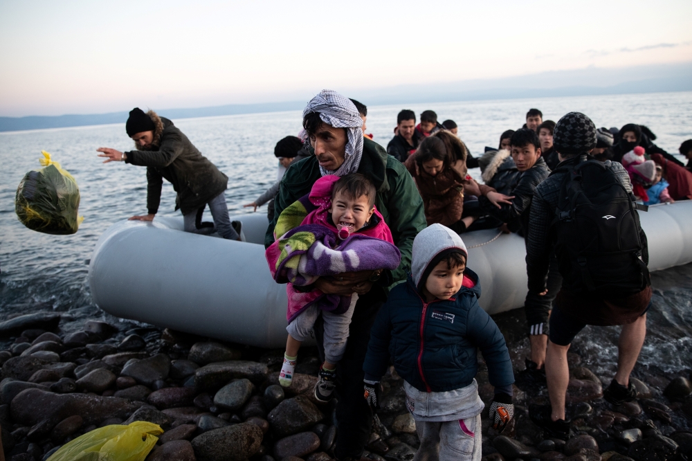 Migrants from Afghanistan arrive on a dinghy on a beach near the village of Skala Sikamias, after crossing part of the Aegean Sea from Turkey to the island of Lesbos, Greece, March 2, 2020. Reuters/Alkis Konstantinidis