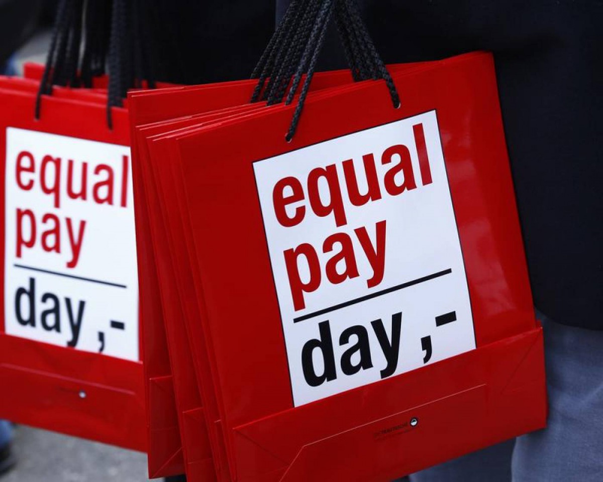 People carry bags reading ‘Equal Pay Day’ during a protest a day before International Women’s Day, in Bern March 7, 2015. Reuters / Ruben Sprich