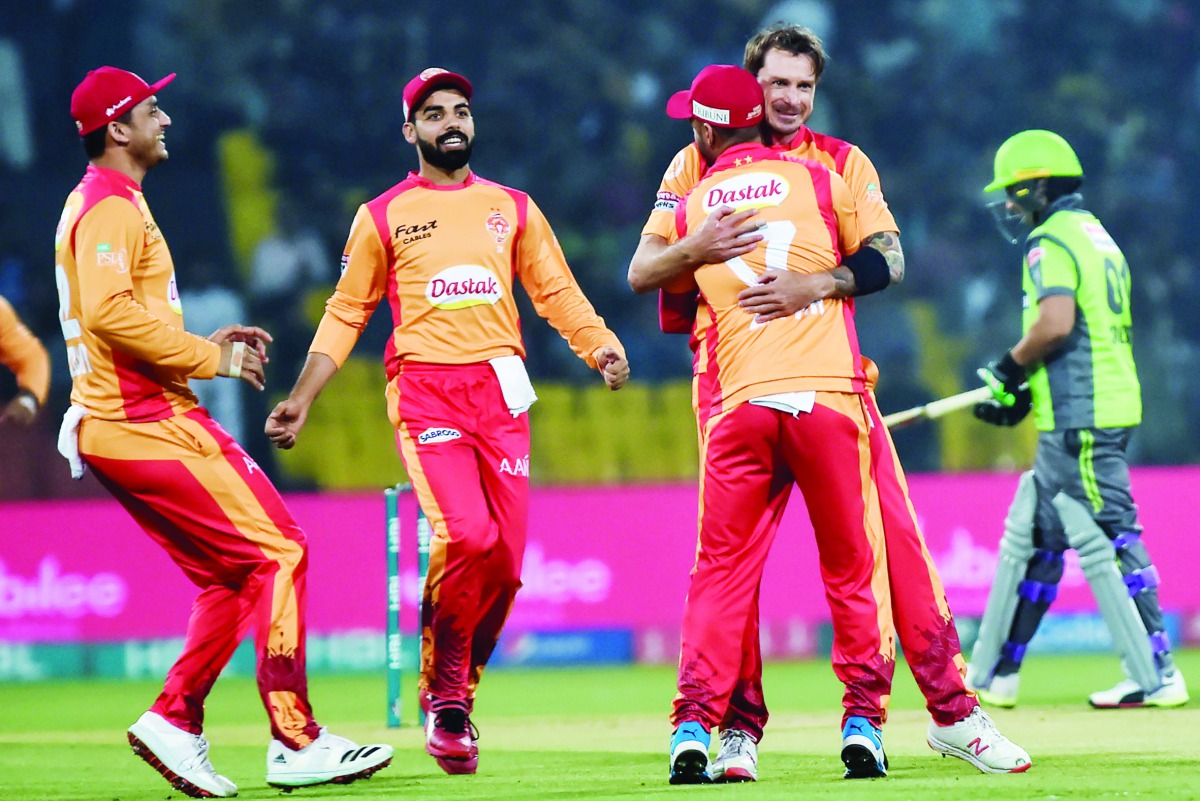 Islamabad United's Dale Steyn (2nd-R) celebrates with teammates after taking the wicket of Lahore Qalandars's Chris Lynn during the Pakistan Super League (PSL) T20 cricket match between Lahore Qalandars and Islamabad United at the Gaddafi Cricket Stadium 