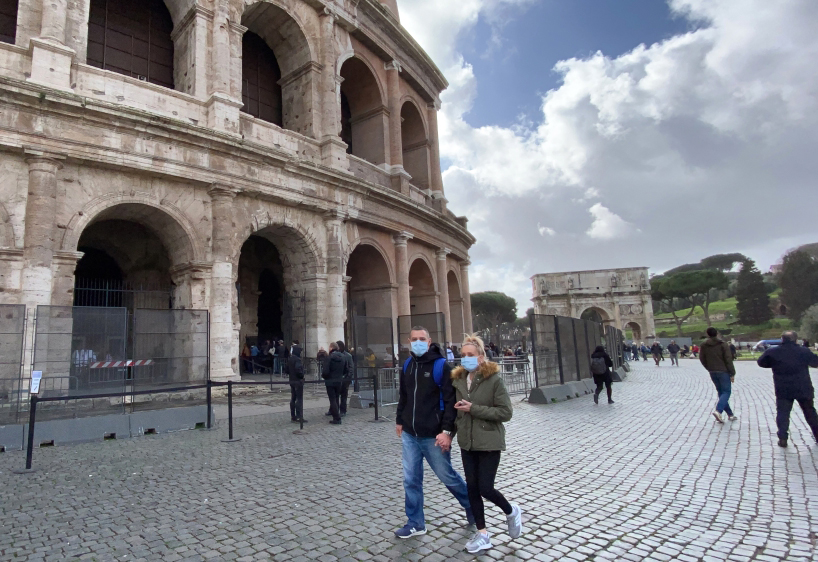People wear face masks as a precaution not to being exposed to the coronavirus walking around Collesium in Rone, Italy on March 6, 2020. Bar?? Seçkin - Anadolu