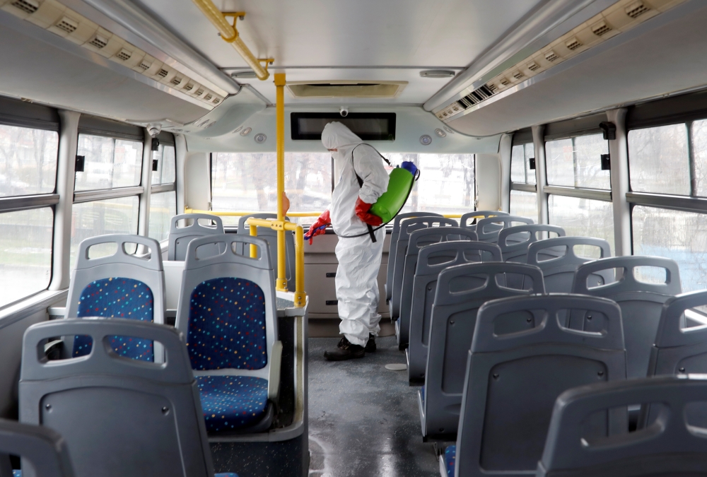 A staff member at city transport company wearing protective clothing disinfects a bus as new coronavirus disease (COVID-19) cases are reported in Skopje, North Macedonia March 7, 2020.REUTERS/Ognen Teofilovski