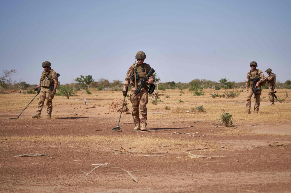 French Army soldiers holds detectors while searching for the presence of Improvised Explosive Devices during the Burkhane Operation in northern Burkina Faso on November 12, 2019. AFP / Michele Cattani