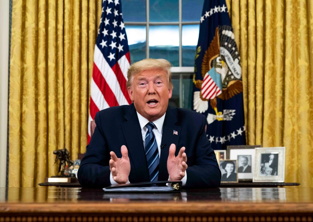 US President Donald Trump addresses the Nation from the Oval Office about the widening novel coronavirus (Covid-19) crisis in Washington, DC on March 11, 2020. / AFP / POOL / Doug Mills
